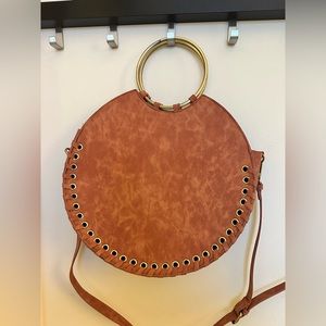 Brown round man made material bag
